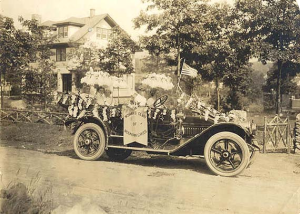The Women’s Club car with its president, Mme. Belle de Rivera at far left, 29 Dartmouth Rd in the background on July 4, 1915
